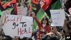 A young girl waves the opposition flag as an angry but peaceful crowd demonstrates outside the Tibesty Hotel where an African Union delegation was meeting with opposition leaders in Benghazi, Libya, April 11, 2011