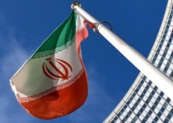 FILE - The Iranian national flag is seen outside the International Atomic Energy Agency (IAEA) headquarters during the agency's Board of Governors meeting in Vienna, March 1, 2021.