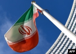 FILE - The Iranian national flag is seen outside the International Atomic Energy Agency (IAEA) headquarters during the agency's Board of Governors meeting in Vienna, March 1, 2021.