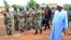 Mali's President Ibrahim Boubacar Keita, right, reviews troops in Kati, near Bamako, after visiting soldiers injured in an attack on their camp in northern Mali earlier in the week that left 11 other soldiers dead, Aug. 6, 2015.
