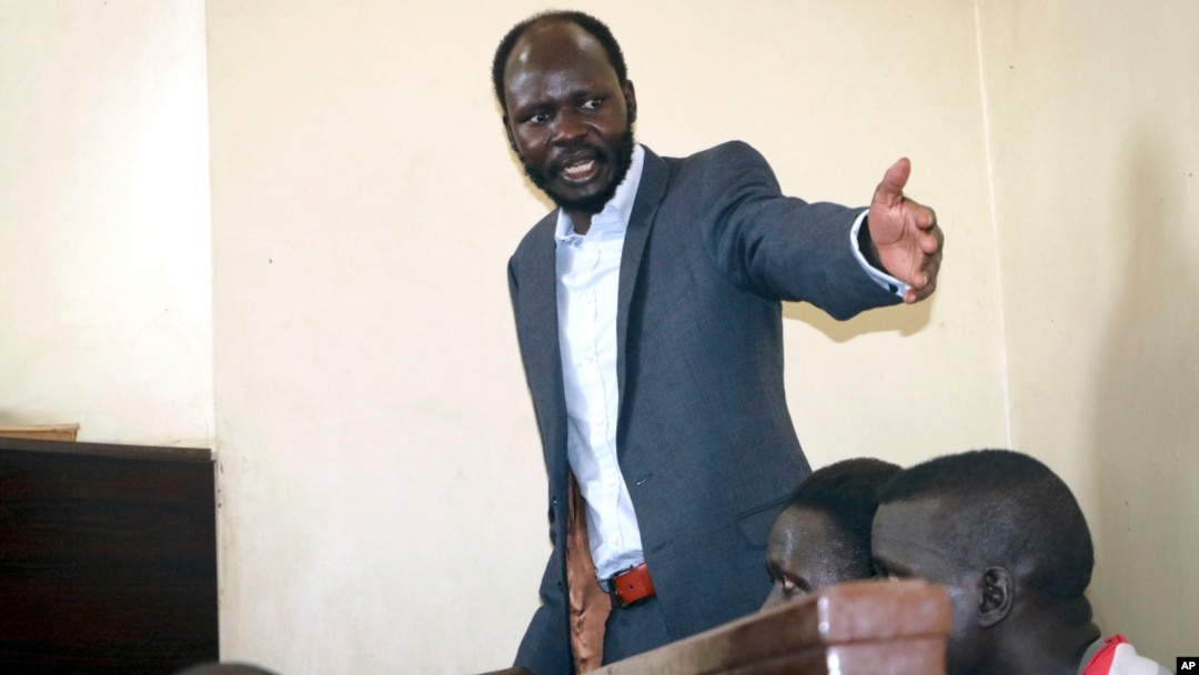 FILE - South Sudanese academic and activist Peter Biar Ajak, gestures during his trial in the capital Juba, South Sudan, March 25, 2019.