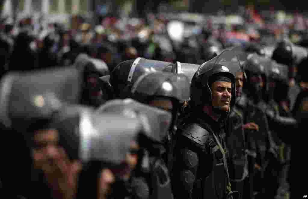 Egyptian riot police stand guard during a demonstration by supporters of ousted President Mohamed Morsi, near Tahrir Square in Cairo, July 17, 2013.