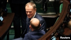 Leader of the Civic Coalition Donald Tusk reacts on the day Poland's Prime Minister Mateusz Morawiecki presents his government's program and asks parliament for a vote of confidence in Warsaw, Poland, Dec. 11, 2023.