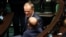 Leader of the Civic Coalition Donald Tusk reacts on the day Poland's Prime Minister Mateusz Morawiecki presents his government's program and asks parliament for a vote of confidence in Warsaw, Poland, Dec. 11, 2023.
