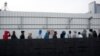 African migrants wait in line for the opening of the Population and Immigration Authority office in Bnei Brak, Israel, Feb. 4, 2018. 