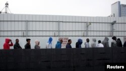 African migrants wait in line for the opening of the Population and Immigration Authority office in Bnei Brak, Israel, Feb. 4, 2018. 