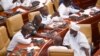 FILE - Members of Parliament of Ghana interact during a break from electing a new leader of parliament in Accra, Ghana, on Jan. 7, 2021. 