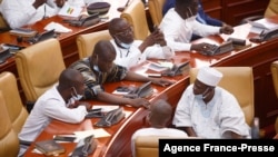 FILE - Members of Parliament of Ghana interact during a break from electing a new leader of parliament in Accra, Ghana, on Jan. 7, 2021. 