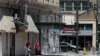 People walk past shuttered businesses in downtown Stockton, California