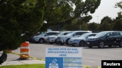 FILE - A sign is seen outside a ballot drop-off site in Houston, Texas, Oct. 1, 2020. 