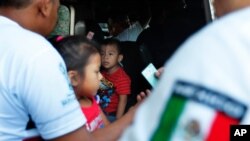 Mexican migration officials check peoples' identification cards at a checkpoint in Tapachula, Chiapas state, Mexico, June 9, 2019.