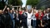 United Kingdom, The Beatles cover band members pose for a photograph with fans on the zebra crossing on Abbey Road in London