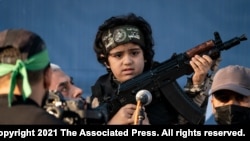 یحیی سینوار، رهبر حماس، یک کودک سلاح به دست را بغل کرده است