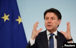 FILE - Italian Prime Minister Giuseppe Conte speaks during a news conference due to coronavirus spread, in Rome, Italy, March 11, 2020.