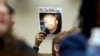 Mattie Scott holds up a picture of her son George during a hearing of the House Judiciary Committee on gun violence at Capitol Hill in Washington, Feb. 6, 2019.