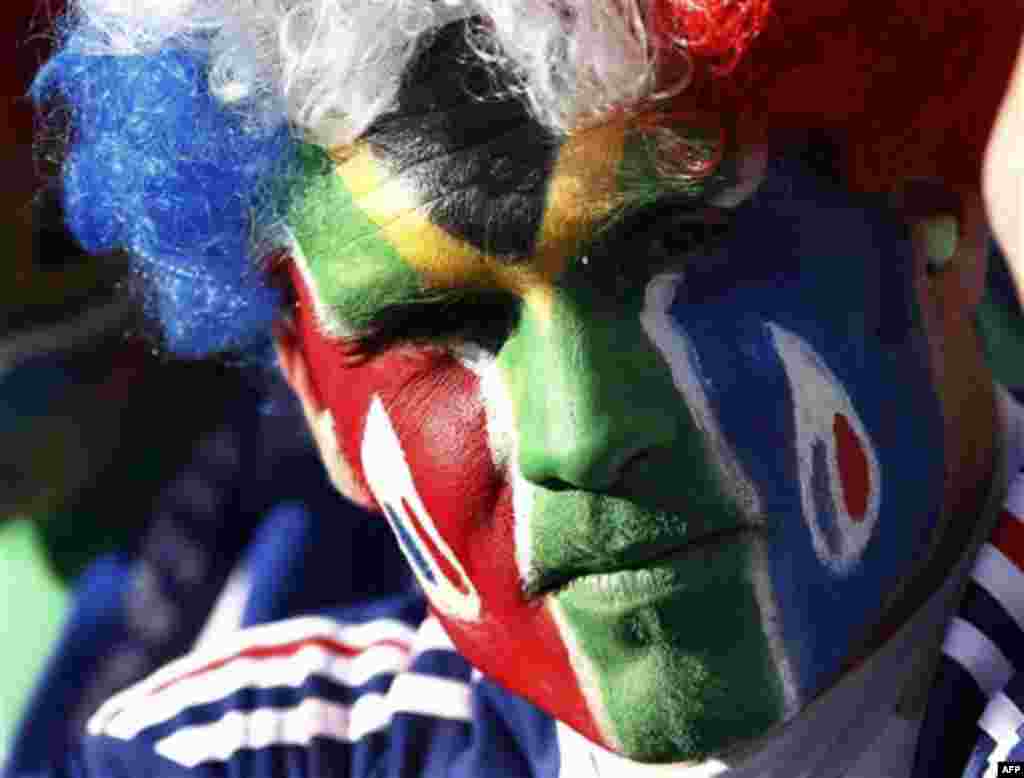 A supporter with the colors of the South Africa and France flags painted on his face waits for the start of the World Cup group A soccer match between France and South Africa at Free State Stadium in Bloemfontein, South Africa, Tuesday, June 22, 2010. (A