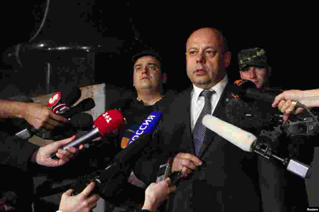 Ukrainian Energy Minister Yuri Prodan talks to journalists as he leaves after talks with members of the Russian delegation and EU Energy Commissioner Guenther Oettinger (not pictured), June 16, 2014.