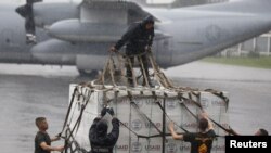 U.S. and Philippine military personnel prepare boxes containing tent material from U.S. relief organisation USAID to be deployed by airlift to the victims of super typhoon Haiyan, at a Manila airport November 13, 2013. Philippine officials have been overw