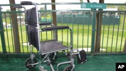 FILE - A wheelchair sits in the viewing area of the ALS Center of Excellence at the TPC River Highlands golf course, June 19, 2017. Tournament officials built a special tent and viewing area for fans with amyotrophic lateral sclerosis.