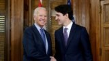 FILE - Canada's Prime Minister Justin Trudeau shakes hands with then-U.S. Vice President Joe Biden during a meeting in Trudeau's office on Parliament Hill in Ottawa, Ontario, Dec. 9, 2016. Biden leaves March 23, 2023, for his first visit to Ottawa as president.