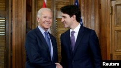 FILE - Canada's Prime Minister Justin Trudeau (R) shakes hands with then U.S. Vice President Joe Biden during a meeting in Trudeau's office on Parliament Hill in Ottawa, Ontario, Canada, Dec. 9, 2016.