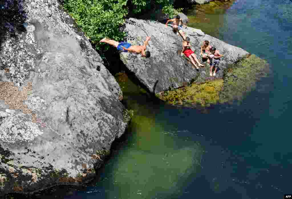 A young man dives in the Treska River near Skopje, Macedonia, as temperatures reach 37&#176; C (98.6&#176; F).