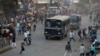 Indians throw stones on police vehicles during a protest against the Citizenship Amendment Act and the National Register of Citizens in Ahmadabad, India, Dec. 19, 2019. 