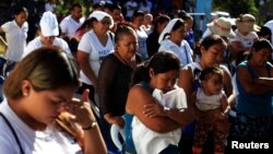 People pray during a ceremony to declare their communities a peace zone at La Selva neighborhood in Ilopango, El Salvador, Feb. 3, 2017. 