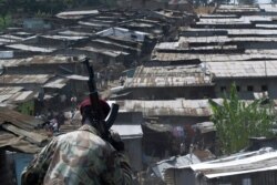 FILE - A member of the police enters Mathare, a slum in Nairobi, Kenya, June 7, 2007.