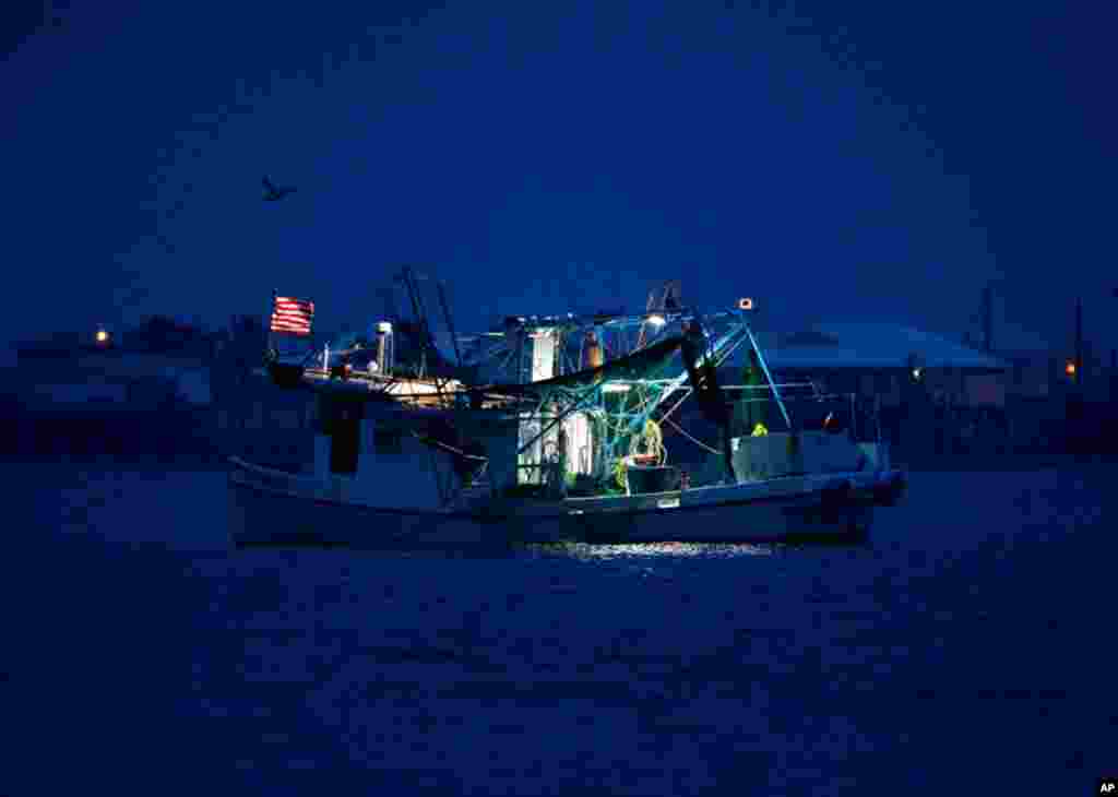 April 20: A commercial fishing boat sits anchored before sunrise in Grand Isle, La., a year after the Deepwater Horizon oil spill. (AP Photo/Patrick Semansky)