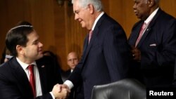 FILE - Rex Tillerson (C), the former chairman and chief executive officer of Exxon Mobil, shakes hands with U.S. Senator Marco Rubio (R-FL) as he arrives for a Senate Foreign Relations Committee confirmation hearing to become U.S. Secretary of State on Ca