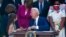 President Joe Biden talks with Logan Evans and Abigail Evans, children of USCP Officer William "Billy" Evans, before signing a bill in the Rose Garden of the White House, Aug. 5, 2021.