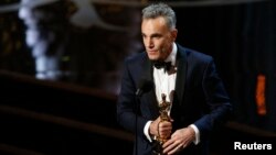FILE - Daniel Day Lewis accepts the Oscar for best actor for his role in "Lincoln," at the 85th Academy Awards in Hollywood, California, Feb. 24, 2013.