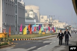 FILE - Pakistani officials walk before the inaugural ceremony of The Chashma-III reactor, a collaboration with China, in Chashma, in this handout photograph released by Pakistan Prime Minister's Office, Dec. 28, 2016.