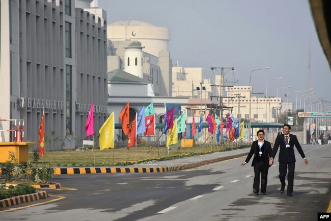 FILE - Pakistani officials walk before the inaugural ceremony of The Chashma-III reactor, a joint collaboration with China, in Chashma, in this handout photograph released by Pakistan Prime Minister's Office, Dec. 28, 2016.