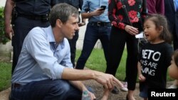 U.S. Rep. Beto O'Rourke, running for the U.S. Senate seat, greets a young supporter following a campaign rally at Texas Southern University in Houston, Texas, Oct. 9, 2018. 