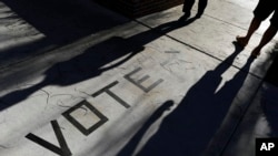 FILE - In this Nov. 6, 2018 file photo, voters head to the polls at the Enterprise Library in Las Vegas. 