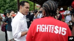 In this May 23, 2019, photo, Democratic presidential candidate and former U.S. Department of Housing and Urban Development Julian Castro speaks with a supporter in Durham, N.C.