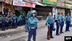 FILE - Police personnel stand guard in front of the Bangladesh Nationalist Party headquarters in Dhaka on Nov. 19, 2023, during a nationwide strike called by BNP activists. The party said about half of its five million members "face politically motivated prosecution."