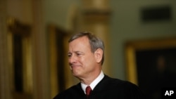 FILE - Chief Justice of the United States John Roberts walks to the Senate chamber at the Capitol in Washington, Jan. 16, 2020. 