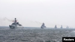 FILE - Chinese Navy warships take part in an international fleet review.