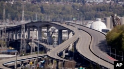 Several work vehicles are parked atop the West Seattle Bridge following an emergency closure several weeks earlier, April 15, 2020, in Seattle.