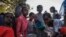 Displaced children from Western Tigray gather at meal time to receive food outside a classroom in the school where they are sheltering in Tigray's capital Mekele, Ethiopia, Feb. 24, 2021.