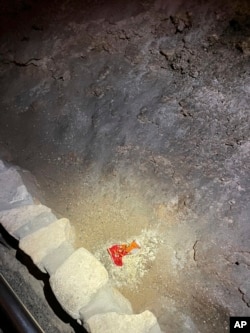 This undated photo shows a bag of Cheetos that was dropped off the trail by a visitor in the Big Room at the national park near Carlsbad, N.M. (Carlsbad Caverns National Park via AP)