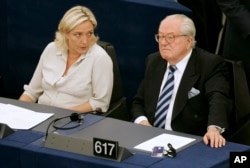 FILE - Jean-Marie Le Pen, right, and his daughter Marine Le Pen sit at the European Parliament, in Strasbourg, France, on July 14, 2009.