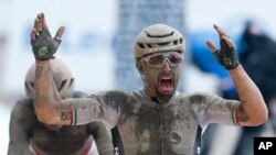 Sonny Colbrelli of Italy celebrates as he crosses the finish line ahead of Florain Vermeersch of Belgium, rear and second place, to win the men&#39;s Paris Roubaix, a 258 kilometer (160.3 miles) one-day-race cycling race, at the velodrome in Roubaix, northern France.