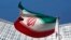 FILE - An Iranian flag flutters in front of the United Nations headquarters in Vienna, June 17, 2014. 