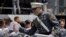 A West Point cadet gets a high five from a friend after receiving his diploma during graduation ceremonies at the United States Military Academy, Saturday, May 26, 2018, in West Point, N.Y.