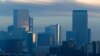 FILE - Pollution obscures the skyline of downtown as the sun rises over Denver, Feb. 28, 2019.