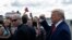 U.S. President Donald Trump pumps his fist as he arrives at Ocala International Airport in Ocala, Fla., Oct. 3, 2019.